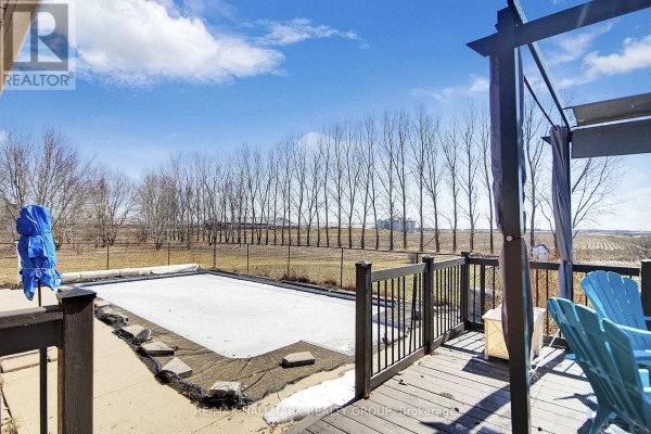 Covered swimming pool and wooden deck with outdoor seating - 6151 Malakoff Road Ottawa