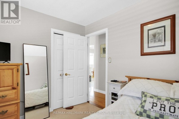 Bedroom with wooden dresser, full-length mirror, and bed - 6151 Malakoff Road Ottawa