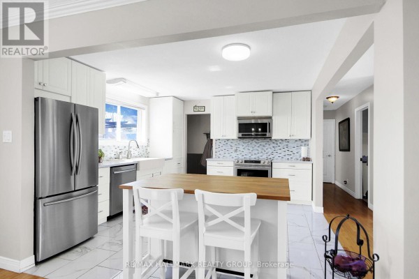 Modern kitchen with butcher block island and farmhouse sink - 6151 Malakoff Road Ottawa