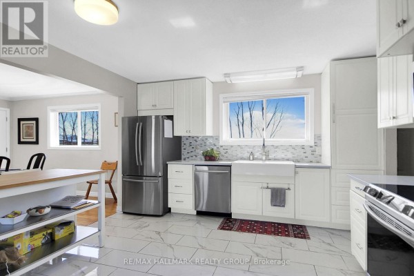 Renovated kitchen with farmhouse sink, white cabinets, and stainless steel appliances - 6151 Malakoff Road Ottawa
