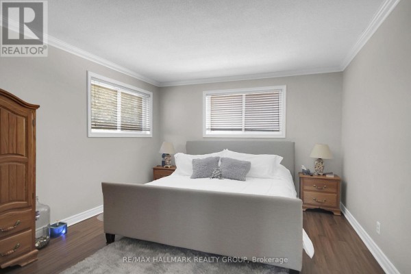 Bedroom with king bed, bedside tables, wardrobe, and laminate floors - 6151 Malakoff Road Ottawa