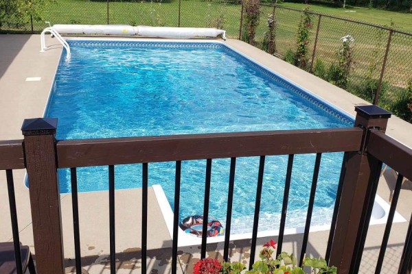 Rectangular swimming pool with a cover, deck, and flowers - 6151 Malakoff Road Ottawa