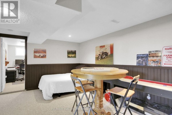 Basement with bed, shuffleboard, and motorcycle art - 6151 Malakoff Road Ottawa
