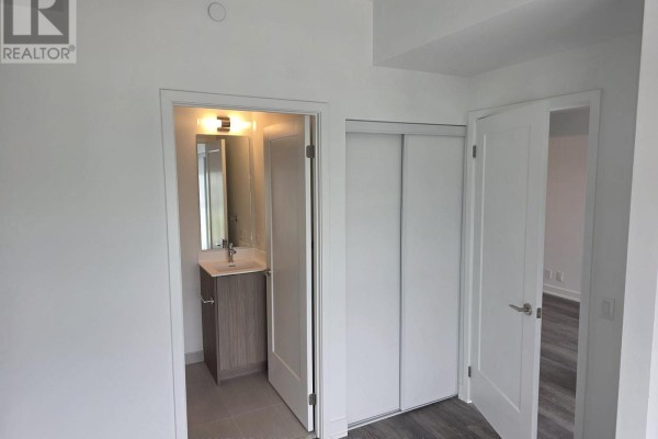 Interior view of a modern apartment with a visible bathroom and closet. - 617 - 20 Deans Drive, Toronto