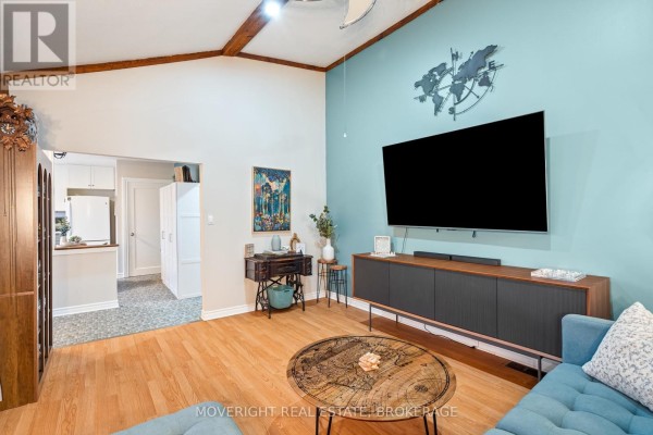 Cozy living area with a sectional sofa and decorative wall art - 618 Lincoln Street, Welland