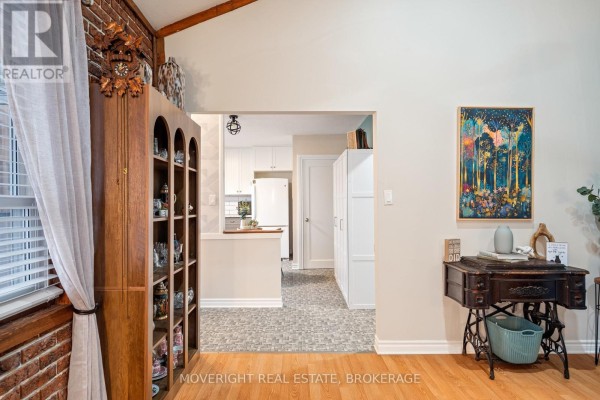 View from living room into kitchen area with open layout and light-colored cabinetry - 618 Lincoln Street, Welland