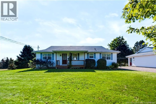 Front view of the white residential house with a green lawn and trees. - 618 Route 935, Wood Point