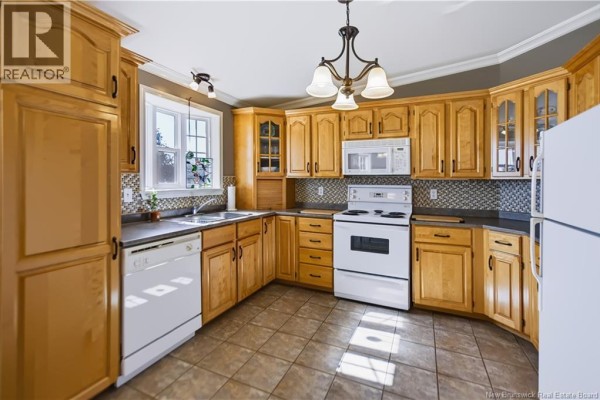 U-shaped kitchen with light wood cabinets, white appliances, and a window above the sink. - 618 Route 935, Wood Point