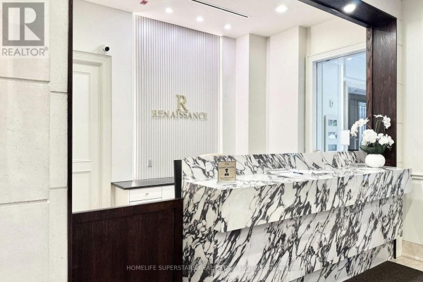 Marble reception desk with "Renaissance" signage in the building lobby. - 619 - 10101 Yonge Street, Richmond Hill
