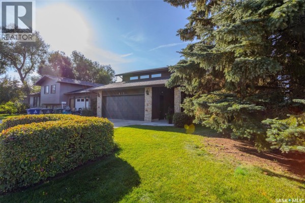 A three-quarter view of the house, highlighting its exterior materials and landscaping. - 619 Clover Avenue, Dalmeny