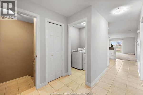 White kitchen cabinets, granite countertops, white appliances, and breakfast bar with white cabinetry below. - 619 Rodfam, Windsor