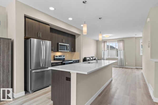 Exterior view of townhouse with multiple levels and stone accents - #62 13139 205 St Nw, Edmonton