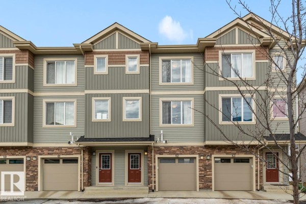 Spacious kitchen island with sink, stainless steel dishwasher, and natural light - #62 13139 205 St Nw, Edmonton