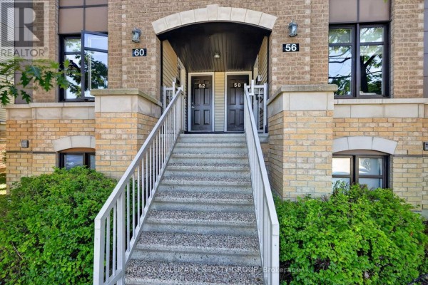 Exterior view of a townhouse entrance with a stone facade and grey stairs. - 62 Argent Private, Ottawa