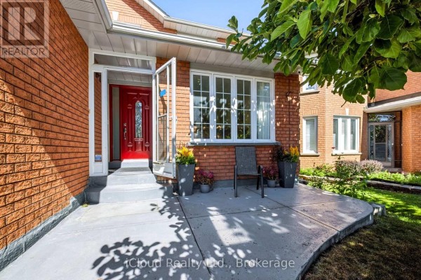 Front entrance with a red door, glass storm doors, and concrete porch. - 62 Castlehill Crescent, Brampton