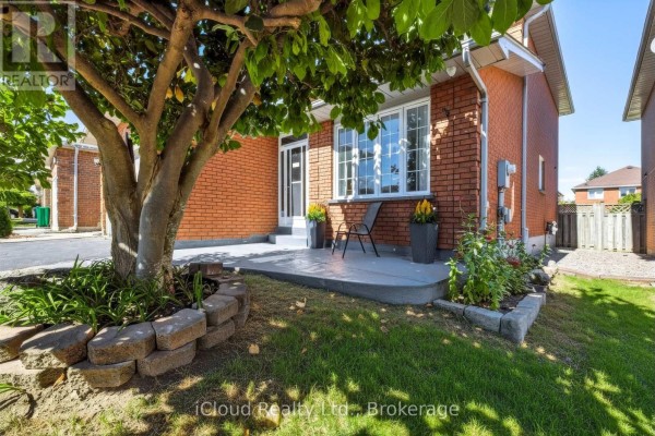 Side view of a brick house with a concrete patio and a large tree. - 62 Castlehill Crescent, Brampton