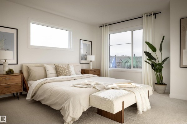 Bedroom with a king-size bed, neutral bedding, two windows, and wood bedside tables. - 62 Cessy St, St  Albert