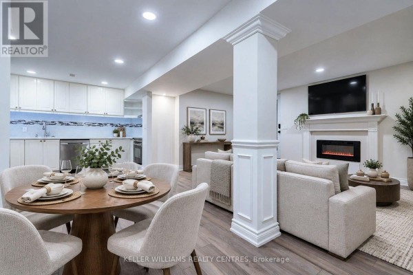 Finished basement with a dining area, living room, fireplace, and television. - 62 Corner Ridge Road, Aurora
