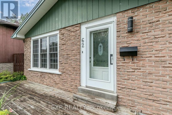 Close-up of the front door entrance with brick exterior, wooden porch, and mailbox. - 62 Courtice Crescent, Collingwood