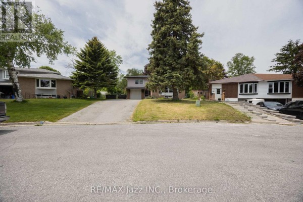Street view of a detached suburban house with a driveway and lawn, flanked by similar properties. - 62 Crossley Drive, Port Hope