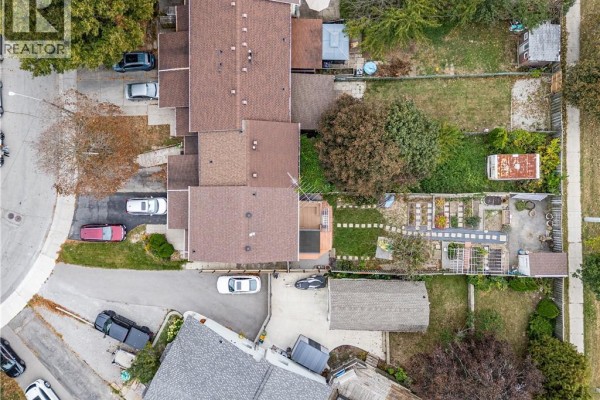 Aerial view of townhouse complex showing individual units, driveways, and backyards. - 62 Gledhill Crescent, Hamilton