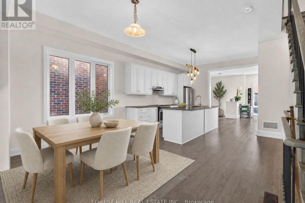 Open concept dining area with wooden table and chairs, adjacent to a modern kitchen. - 62 Hesperus Road, Vaughan