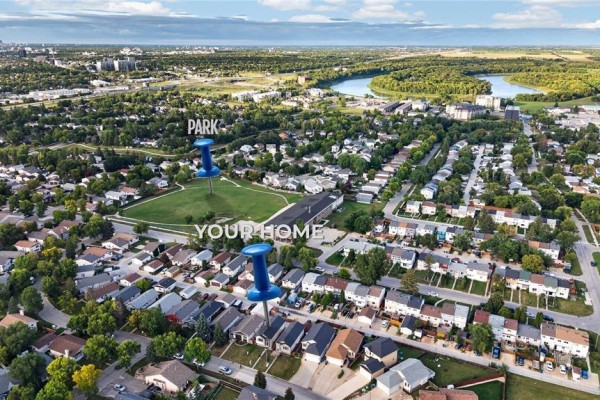 Aerial overview of Winnipeg highlighting the proximity of the home to a park and river. - 62 La Porte Drive, Winnipeg