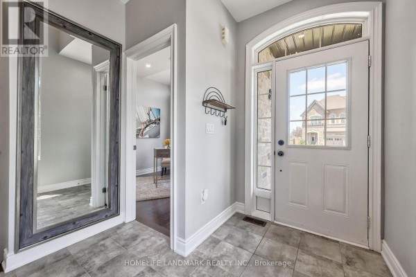 Interior entryway with a white door, large mirror, and tile floor. - 62 Ladder Crescent, East Gwillimbury