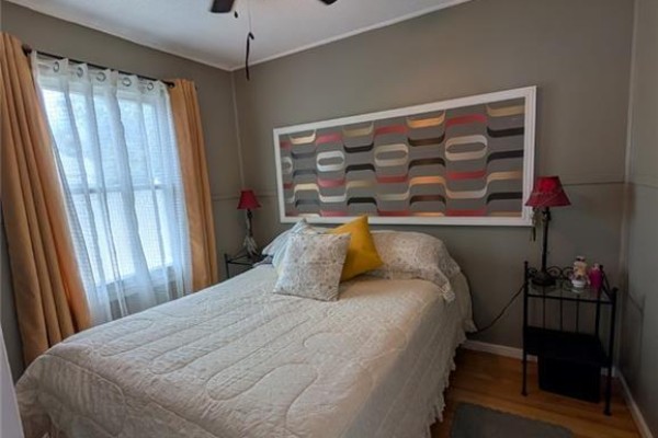 Bedroom with bed, ceiling fan, and decorative headboard - 62 Ninth Avenue Brantford