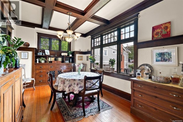 Dining room featuring a round table, hardwood floors, a buffet, and large windows. - 62 Obed Ave, Saanich