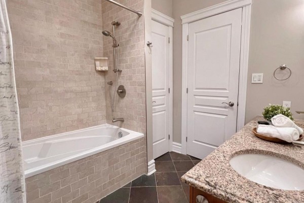 Bathroom with bathtub, shower, granite vanity, and tiled walls. - 62 Rebecca Crescent, Ottawa