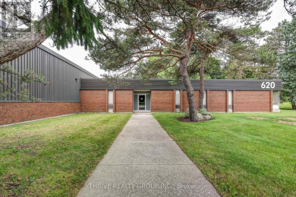 Expansive, empty commercial warehouse with a high ceiling, exposed beams, concrete floor, and yellow lane markers. - 620 Ireland Road, Norfolk