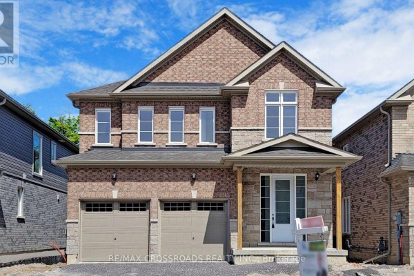 View of the front entrance and garage doors of a modern brick home. - 620 Lemay Grove, Peterborough
