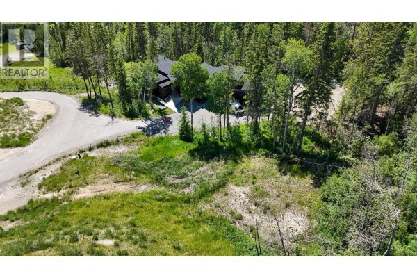 View of modern house surrounded by trees and a winding road. - 6200 Columbia Lake Road Road Lot# 2, Fairmont Hot Springs