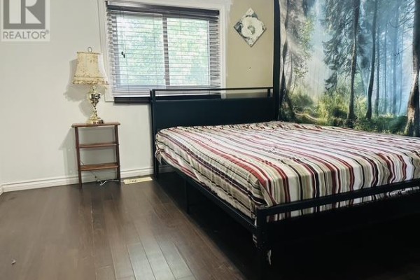 Bedroom with bed and forest mural - 622 Placid Ave Sault Ste Marie