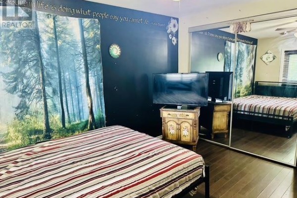 Bedroom with tree mural, two TVs, and mirrored closet - 622 Placid Ave Sault Ste Marie