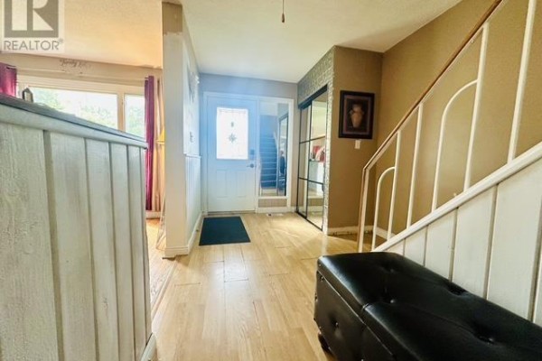 Hallway with hardwood floors, staircase, and large window - 622 Placid Ave Sault Ste Marie
