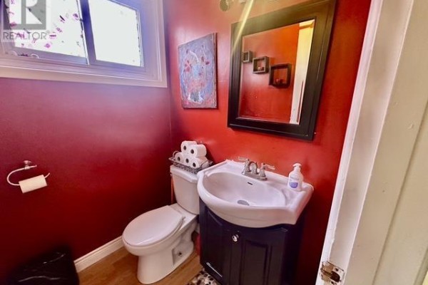 Bathroom with toilet, sink, and mirror - 622 Placid Ave Sault Ste Marie