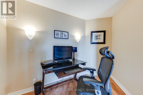 Wide view of the combined living, dining, and kitchen area with wood floors. - 623 - 1720 Eglinton Avenue E, Toronto