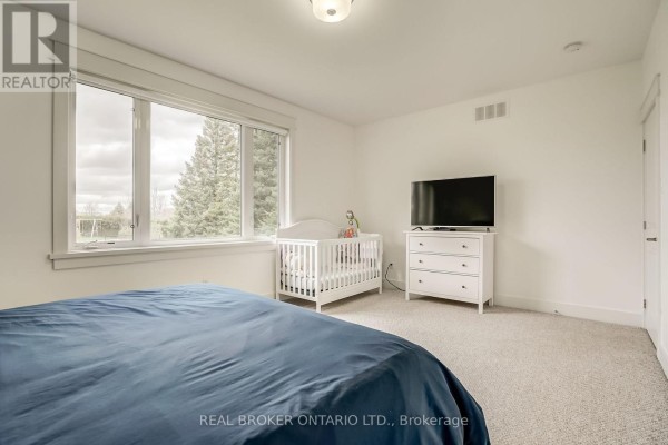 Another angle of the home office showing the desk and window view. - 6237 Perth Street, Ottawa
