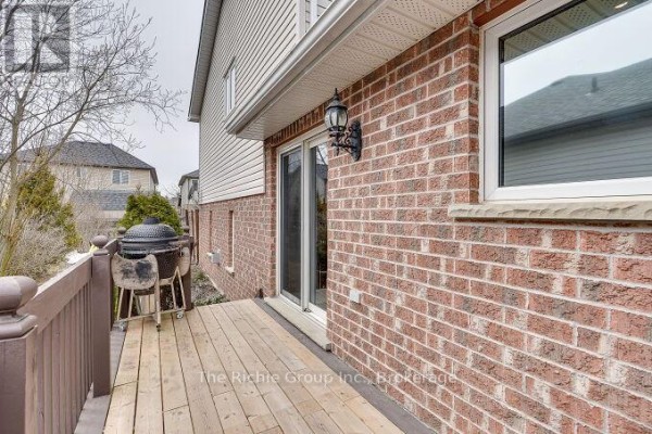 Wooden deck with grill and sliding glass door on a brick house - 624 Cedar Street W Shelburne