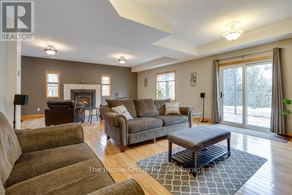 Living room with fireplace and sliding glass door - 624 Cedar Street W Shelburne