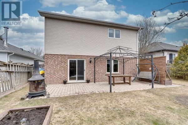 Backyard with patio, gazebo, outdoor fireplace, swing bench - 624 Cedar Street W Shelburne