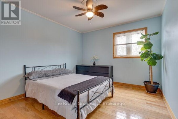 Bedroom with bed, dresser, ceiling fan, and plant - 624 Cedar Street W Shelburne