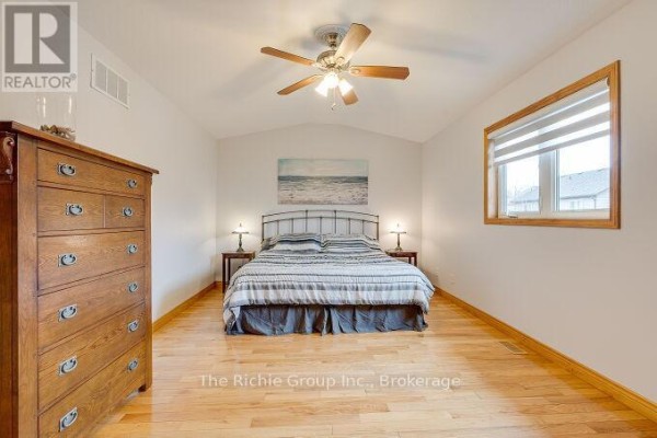 Bedroom with queen bed, wooden dresser, and vaulted ceiling - 624 Cedar Street W Shelburne