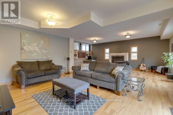 Living room with fireplace, sofas, and hardwood floors - 624 Cedar Street W Shelburne