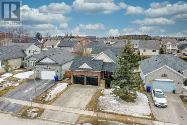 Exterior view of brick and stone houses with garages and driveways - 624 Cedar Street W Shelburne