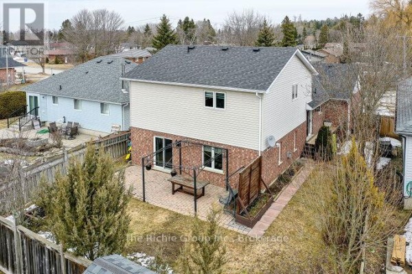 Backyard with paved patio, pergola, and outdoor dining set - 624 Cedar Street W Shelburne