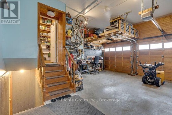 Garage with snowblower, bikes, workbench, and pantry - 624 Cedar Street W Shelburne
