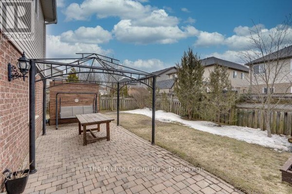 Brick patio with gazebo and picnic table, grassy backyard - 624 Cedar Street W Shelburne